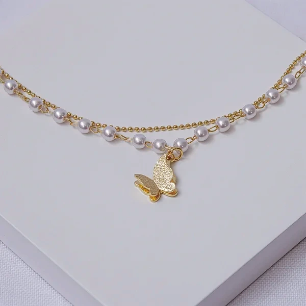 Pulseira dourada dupla bolinhas e pérolas com borboleta